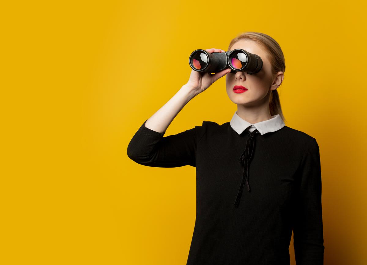 Woman searches for something with binoculars 